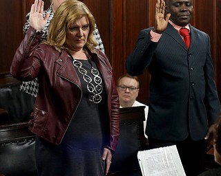 Joseph Tetteh Odonkor and Cnthia Norma Rogers raise their hands during a naturalization ceremony, Thursday, Jan. 24, 2018, at the Mahoning County Courthouse in Youngstown...(Nikos Frazier | The Vindicator)