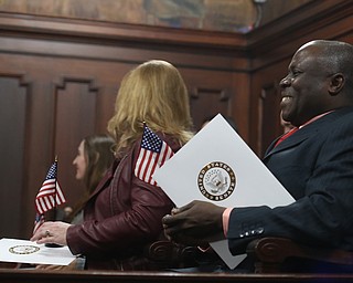Joseph Tetteh Odonkor holds his new flag during a naturalization ceremony, Thursday, Jan. 24, 2018, at the Mahoning County Courthouse in Youngstown...(Nikos Frazier | The Vindicator)
