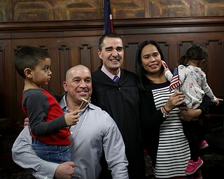 Judge Rusu(center) poses for a photo with Brody(4), Eric, Jeny and Olivia(2) Wilcoxson during a naturalization ceremony, Thursday, Jan. 24, 2018, at the Mahoning County Courthouse in Youngstown...(Nikos Frazier | The Vindicator)