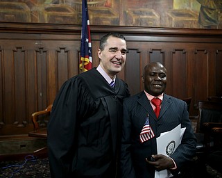 Judge Rusu poses for a photo with Joseph Tetteh Odonkor after Odonkor was sworn in as a US citizen during a naturalization ceremony, Thursday, Jan. 24, 2018, at the Mahoning County Courthouse in Youngstown...(Nikos Frazier | The Vindicator)