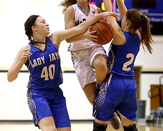 McDonald's Olivia Perry (3) is stripped of the ball by Jackson-Milton forward Abigail Spalding (40) and Jackson-Milton guard Julia Bogden (2) in the first half of an Mahoning Valley Athletic Conference high school basketball game, Monday, Jan. 29, 2018, in McDonald. McDonald won 37-34...(Nikos Frazier | The Vindicator)