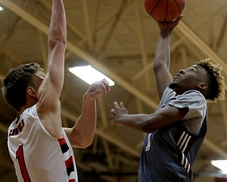 Boardman guard JaJuantae Young (1) goes up for a layup against Canfield's forward Aydin Hanousek (1) in the first quarter of an AAC high school basketball game, Tuesday, Jan. 30, 2018, in Canfield. Canfield won 62-48...(Nikos Frazier | The Vindicator)