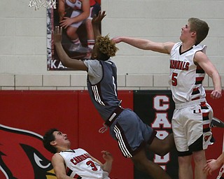 Boardman guard JaJuantae Young (1) goes up for a layup on top of Canfield's guard Ben Shapiro (3) as Canfield's guard Tyler Dobrindt (5) attempts to block the shot from behind in the second quarter of an AAC high school basketball game, Tuesday, Jan. 30, 2018, in Canfield. Canfield won 62-48...(Nikos Frazier | The Vindicator)