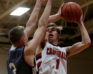Canfield's forward Aydin Hanousek (1) goes up for a layup over Boardman guard Holden Lipke (3) in the second quarter of an AAC high school basketball game, Tuesday, Jan. 30, 2018, in Canfield. Canfield won 62-48...(Nikos Frazier | The Vindicator)