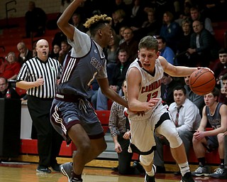 Canfield's guard Ethan Kalina (12) dribbles past Boardman guard JaJuantae Young (1) in the second quarter of an AAC high school basketball game, Tuesday, Jan. 30, 2018, in Canfield. Canfield won 62-48...(Nikos Frazier | The Vindicator)