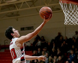 Canfield's forward Spencer Woolley (11) goes up for a layup in the second quarter of an AAC high school basketball game, Tuesday, Jan. 30, 2018, in Canfield. Canfield won 62-48...(Nikos Frazier | The Vindicator)