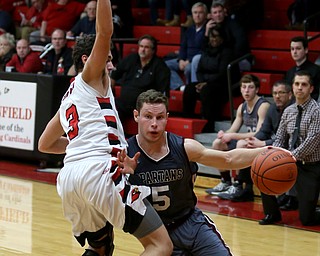 Boardman guard Mike Melewski (5) charges into Canfield's guard Ben Shapiro (3) in the fourth quarter of an AAC high school basketball game, Tuesday, Jan. 30, 2018, in Canfield. Canfield won 62-48...(Nikos Frazier | The Vindicator)