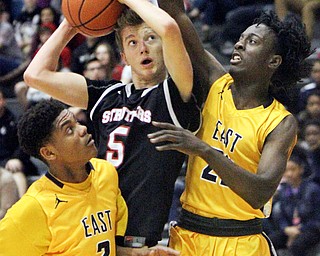 William D. Lewis The Vindicator  Struthers  Carson Ryan(5) drives through East's Timothy Williams(3) and Dontraile Price(22) during 1-30-18 action at East.