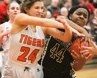 William D Lewis the Vindicator  Howland's Jenna desalvo(24) and Harding'sBraeden Morris(44) battle for the ball during 1-31-18 action at Howland.