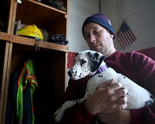 Firefighter Fred Behnke holds Daisy, Friday, Jan. 26, 2018, at the Eagle Joint Fire District in Hubbard...(Nikos Frazier | The Vindicator)