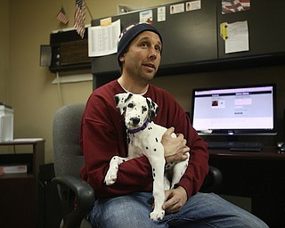 Firefighter Fred Behnke holds Daisy, Friday, Jan. 26, 2018, at the Eagle Joint Fire District in Hubbard...(Nikos Frazier | The Vindicator)