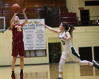 Cardinal Mooney Lauren Frommelt (15) goes up for three as Ursuline's Cara McNally (5) scrambles to try and block her shot in the first quarter of an OSHAA basketball game, Thursday, Feb. 1, 2018, in Youngstown. Ursuline won 76-54...(Nikos Frazier | The Vindicator)