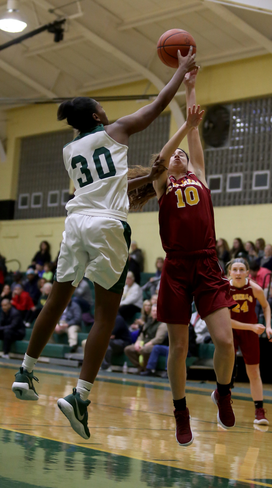 Ursuline's Anyah Curd (30) spikes the ball out of Cardinal Mooney Carolyn Kay (10)s hands as Kay was going up for a layup in the first quarter of an OSHAA basketball game, Thursday, Feb. 1, 2018, in Youngstown. Ursuline won 76-54...(Nikos Frazier | The Vindicator)