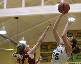 Ursuline's Lindsay Bell (35) goes up for two as Cardinal Mooney Kelly Williams (24) attempts to block her shot in the second quarter of an OSHAA basketball game, Thursday, Feb. 1, 2018, in Youngstown. Ursuline won 76-54...(Nikos Frazier | The Vindicator)