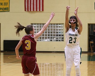 Ursuline's Akneesha Moorman (23) goes up for three as Cardinal Mooney Cameryn Olesh (3) attempts to block her shot in the second quarter of an OSHAA basketball game, Thursday, Feb. 1, 2018, in Youngstown. Ursuline won 76-54...(Nikos Frazier | The Vindicator)