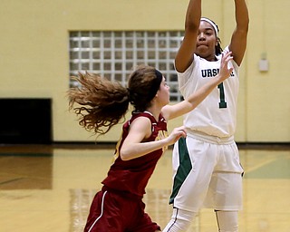 Ursuline's Dayshonette Harris (1) goes up for three as Cardinal Mooney Carolyn Kay (10) attempts to block her shot in the second quarter of an OSHAA basketball game, Thursday, Feb. 1, 2018, in Youngstown. Ursuline won 76-54...(Nikos Frazier | The Vindicator)