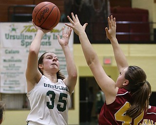 Ursuline's Lindsay Bell (35) puts up two over Cardinal Mooney Conchetta Rinaldi (42) in the third quarter of an OSHAA basketball game, Thursday, Feb. 1, 2018, in Youngstown. Ursuline won 76-54...(Nikos Frazier | The Vindicator)