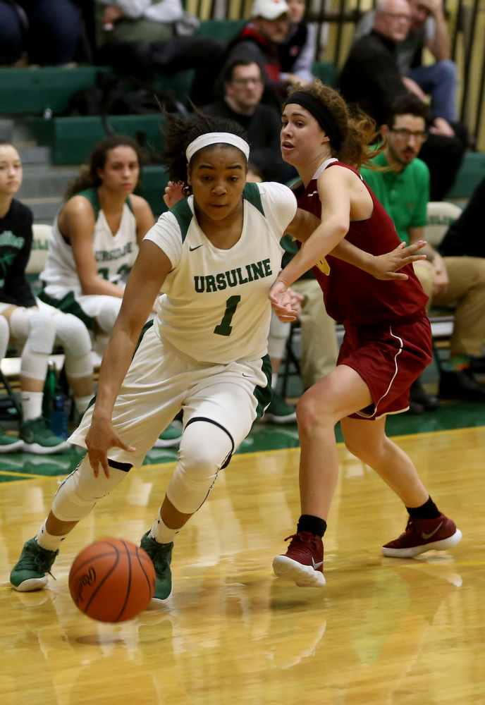 Ursuline's Dayshonette Harris (1) pushes past Cardinal Mooney Carolyn Kay (10) to go up for a layup in the third quarter of an OSHAA basketball game, Thursday, Feb. 1, 2018, in Youngstown. Ursuline won 76-54...(Nikos Frazier | The Vindicator)