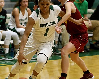 Ursuline's Dayshonette Harris (1) pushes past Cardinal Mooney Carolyn Kay (10) to go up for a layup in the third quarter of an OSHAA basketball game, Thursday, Feb. 1, 2018, in Youngstown. Ursuline won 76-54...(Nikos Frazier | The Vindicator)