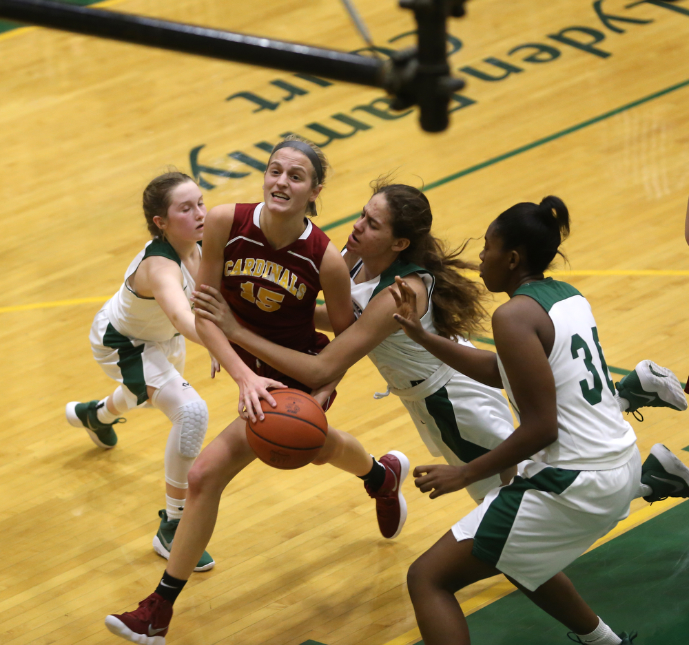 Cardinal Mooney Lauren Frommelt (15) is brought down under the net by Ursuline's Destiny Goodnight (24) in the fourth quarter of an OSHAA basketball game, Thursday, Feb. 1, 2018, in Youngstown. Ursuline won 76-54...(Nikos Frazier | The Vindicator)