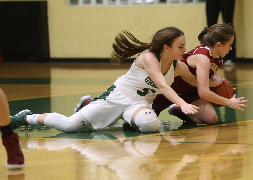 Ursuline's Cara McNally (5) reaches around Cardinal Mooney Camden Hergenrather (14) for the ball in the fourth quarter of an OSHAA basketball game, Thursday, Feb. 1, 2018, in Youngstown. Ursuline won 76-54...(Nikos Frazier | The Vindicator)