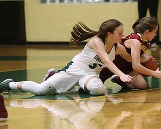 Ursuline's Cara McNally (5) reaches around Cardinal Mooney Camden Hergenrather (14) for the ball in the fourth quarter of an OSHAA basketball game, Thursday, Feb. 1, 2018, in Youngstown. Ursuline won 76-54...(Nikos Frazier | The Vindicator)