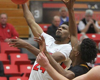 WilliamD. Lewis The Vindicator YSU's Cam More(24) shoots around NKU's Tre Cobbs(3) during 2-1-18 action at YSU.