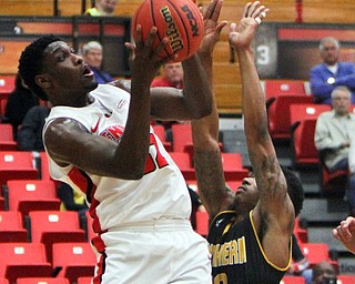 WilliamD. Lewis The Vindicator YSU's Garrett Covington(32) shoots around NKU's Lavonne Holland(30) during 2-1-18 action at YSU.