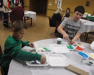 Neighbors | Zack Shively.After the park baked the cookies, families decorated them in sweets, such as icing, sprinkles and candy. Pictured are, from left, Michael and Dylan Short adding a sweetness to their sugar cookies.