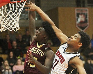 William D. Lewis The Vindicator Liberty's Ezell Brown(15) goes to the hoop as Campbell's Trae Edwards(11) defends during 2-2-18 action at Campbell