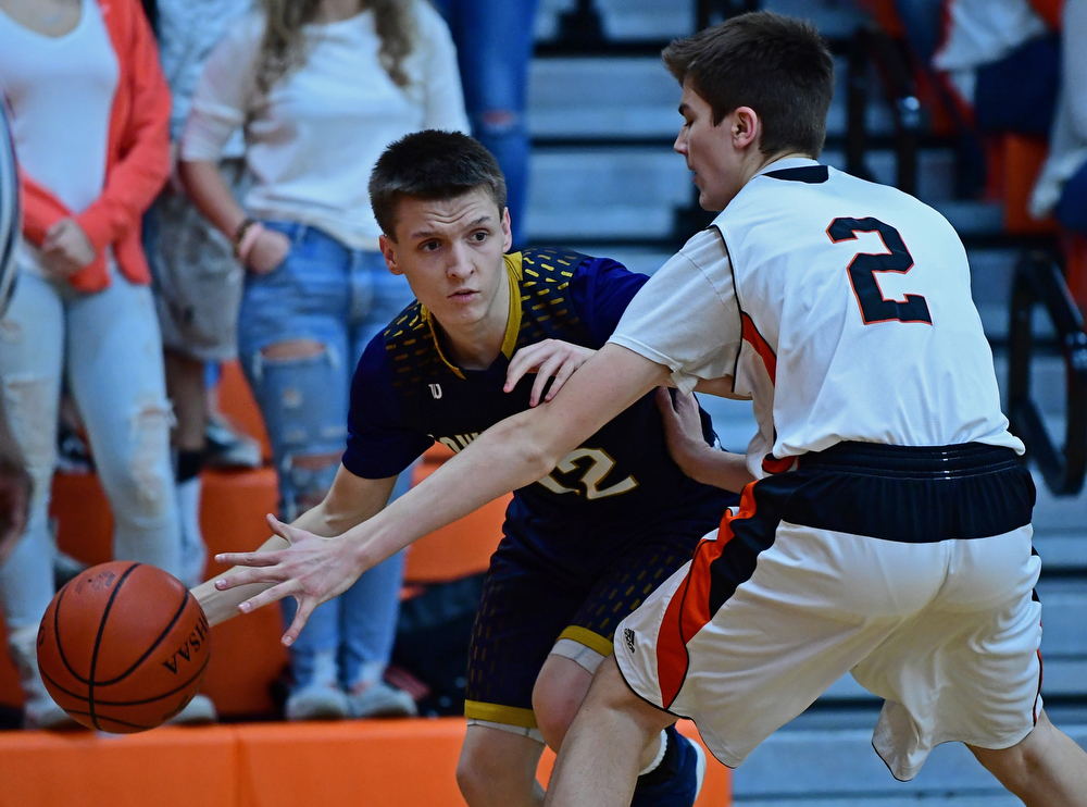 NEW MIDDLETOWN, OHIO - FEBRUARY 2, 2018: Lowellville's Anthony Mesaros looks to pass while being pressured by Springfield's Drew Clark during the first half of their game on Friday night at Springfield High School. DAVID DERMER | THE VINDICATOR