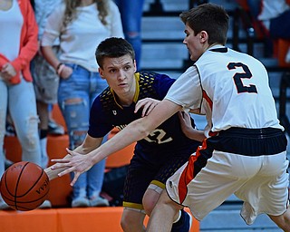 NEW MIDDLETOWN, OHIO - FEBRUARY 2, 2018: Lowellville's Anthony Mesaros looks to pass while being pressured by Springfield's Drew Clark during the first half of their game on Friday night at Springfield High School. DAVID DERMER | THE VINDICATOR