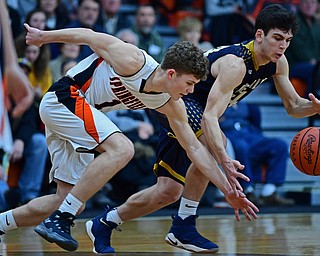 NEW MIDDLETOWN, OHIO - FEBRUARY 2, 2018: Lowellville's Joe Ballone reaches for the ball while Springfield's Evan Ohlin attempts to knock the ball away during the first half of their game on Friday night at Springfield High School. DAVID DERMER | THE VINDICATOR