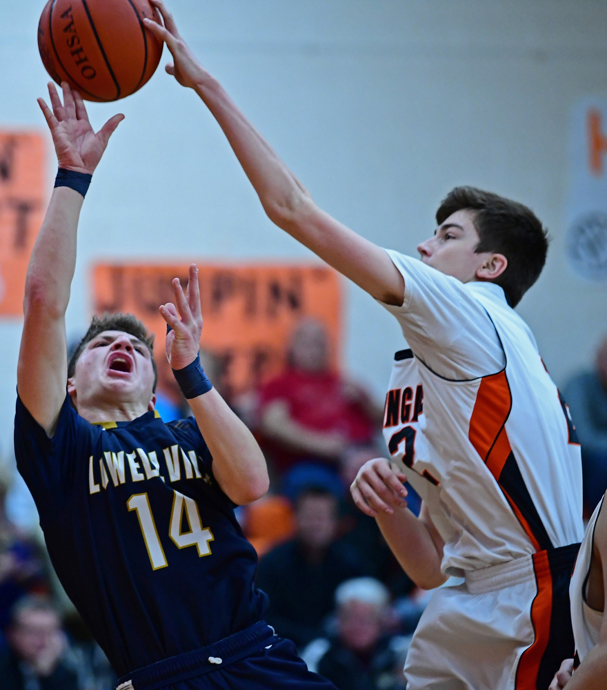 NEW MIDDLETOWN, OHIO - FEBRUARY 2, 2018: Springfield's Drew Clark blocks the shot from Lowellvile's Matt Hvisdak during the first half of their game on Friday night at Springfield High School. DAVID DERMER | THE VINDICATOR