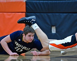 NEW MIDDLETOWN, OHIO - FEBRUARY 2, 2018: Springfield's Evan Ohlin keeps his balance while looking at the ball after being taken down by Lowellville's Nate Solak during the second half of their game on Friday night at Springfield High School. DAVID DERMER | THE VINDICATOR