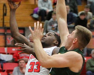 William D. Lewis The Vindicator YSU's Naz Bohannon(33) shoots past WSU's Loudon Love(11)during 2-3-18 action at YSU.