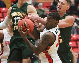 William D. Lewis The Vindicator YSU's Naz Bohannon(33) gets a rebound past  WSU's Grant Benzinger(13) and Parker Ernsthausen(22)during 2-3-18 action at YSU.