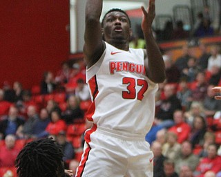 William D. Lewis The Vindicator YSU's Garrett Covington(3) shoots past WSU's Tyler Wilburn(12)during 2-3-18 action at YSU.