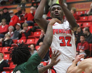 William D. Lewis The Vindicator YSU's Garrett Covington(32) shoots past WSU's Tyler Wilburn(12)during 2-3-18 action at YSU.