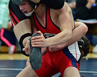 AUSTINTOWN, OHIO - FEBRUARY 3, 2018: Fitch's Gus Sutton controls the foot of Girard's Alex Delgarbino as he clings to his back during their 126lb EOWL Championship bout, Saturday night at Austintown Fitch High School. DAVID DERMER | THE VINDICATOR