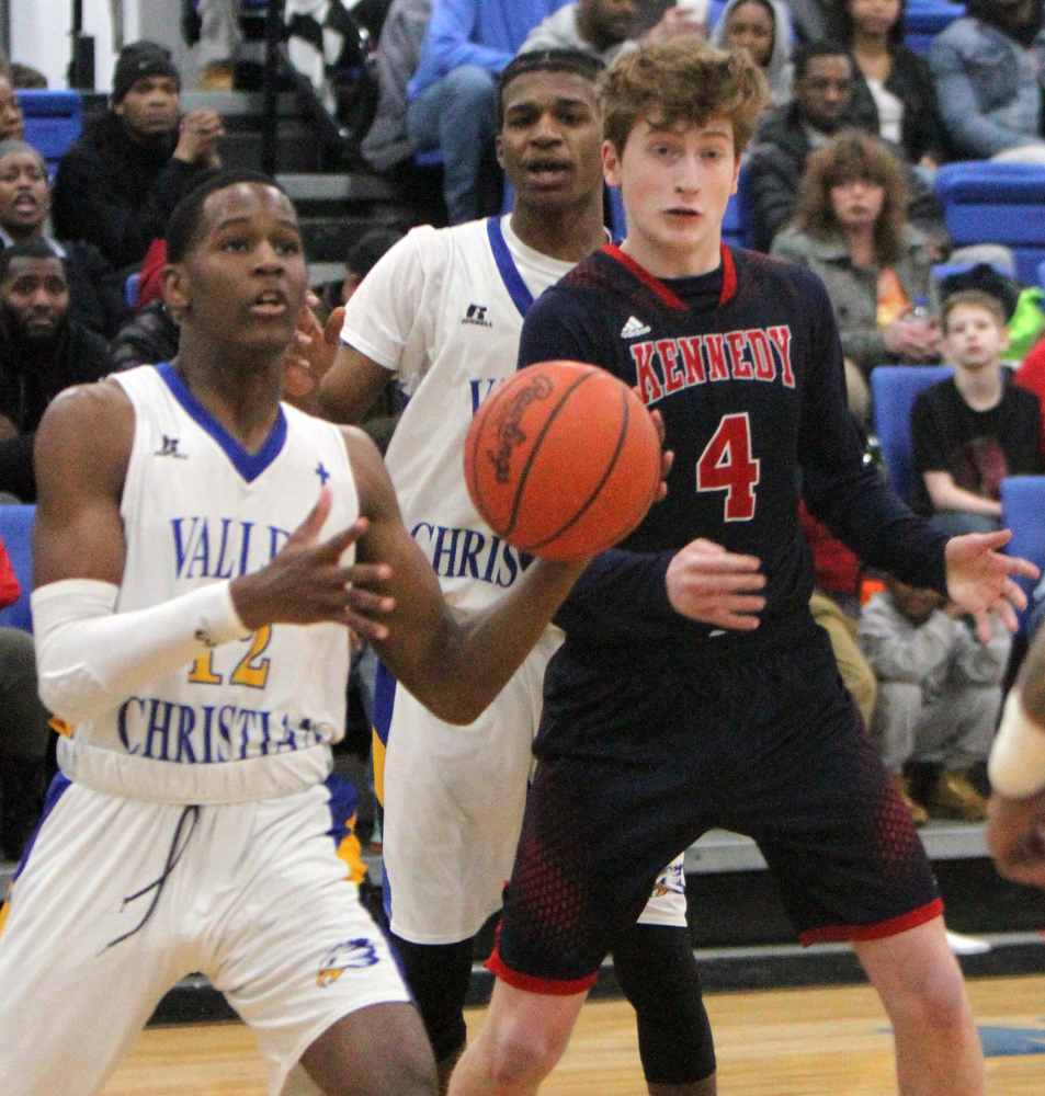 William D Lewis the Vindicator  VCS Melvin Neail(12) passes around JFk'sGianni Eaton(4).