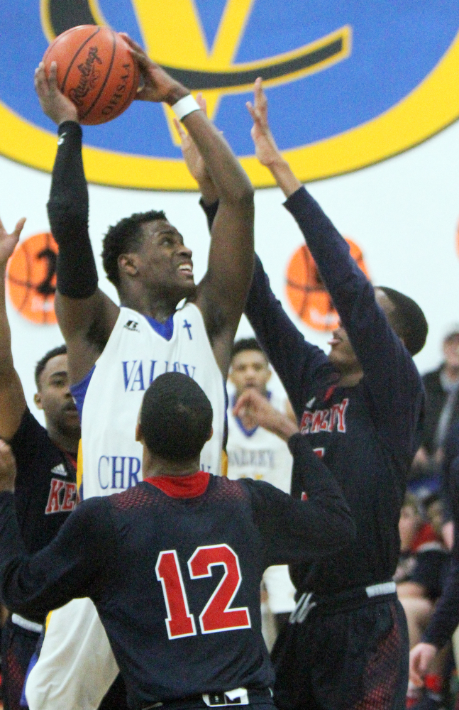 William D Lewis The Vindicator  VCS Milan Square(5) shoots over JFk's Byron Taylor(12) and Tyler James (5).