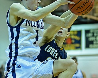 McDONALD, OHIO - FEBRUARY 6, 2018: McDonald's Zach Rasile grabs a rebound away from Lowellville's Joe Ballone during the first half of their game on Tuesday night at McDonald High School. DAVID DERMER | THE VINDICATOR