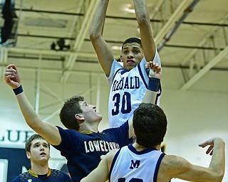 McDONALD, OHIO - FEBRUARY 6, 2018: McDonald's Braedon Poole grabs a rebound away from teammate Josh Calli and Lowellville's Matt Hvisdak during the second half of their game on Tuesday night at McDonald High School. DAVID DERMER | THE VINDICATOR