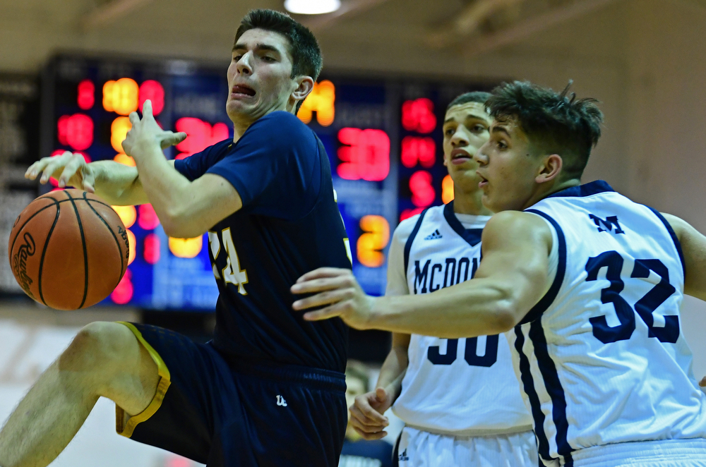 McDONALD, OHIO - FEBRUARY 6, 2018: Lowellville's Joe Ballone loses control of the ball while being pressured by McDonald's Matthew Beedle and Braedon Poole during the second half of their game on Tuesday night at McDonald High School. DAVID DERMER | THE VINDICATOR