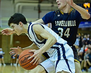 McDONALD, OHIO - FEBRUARY 6, 2018: McDonald's Zach Rasile drives on Lowellville's Dylan Durkin during the second half of their game on Tuesday night at McDonald High School. DAVID DERMER | THE VINDICATOR