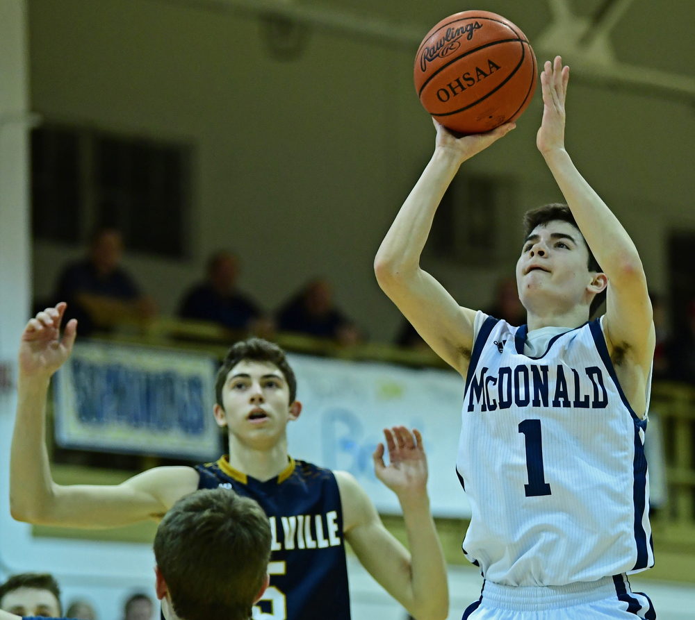 McDONALD, OHIO - FEBRUARY 6, 2018: McDonald's Zach Rasile shoots over Lowellville's Alex Mamula-Zarlingoduring the second half of their game on Tuesday night at McDonald High School. DAVID DERMER | THE VINDICATOR