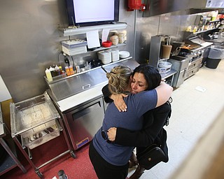 Fidaa Musleh hugs XXXX goodbye before departing for Cleveland Hopkins International Airport, Wednesday, Feb. 7, 2018, at the Downtown Circle Convenience and Deli in Youngstown. ..(Nikos Frazier | The Vindicator)