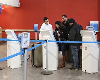 Fidaa Musleh(center) checks into her American Airlines flight, Wednesday, Feb. 7, 2018, at Cleveland Hopkins International Airport in Cleveland. ..(Nikos Frazier | The Vindicator)