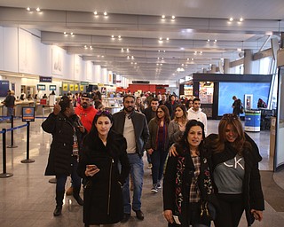 Fidaa Musleh(center), walks with Rana Addullah(right) and Amal Saleh with her family in tow, Wednesday, Feb. 7, 2018, at Cleveland Hopkins International Airport in Cleveland. ..(Nikos Frazier | The Vindicator)